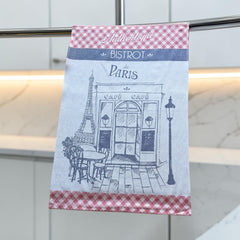 Light blue French tea towel with red gingham borders and a navy illustration of a Paris café and Eiffel Tower, by Coucke.