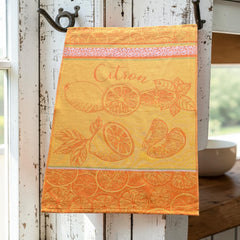 Yellow and orange French tea towel with woven lemon and citrus slice motifs and decorative borders, by Coucke.