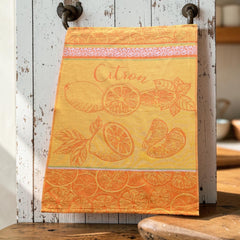 Yellow and orange French tea towel with woven lemon and citrus slice motifs and decorative borders, by Coucke.