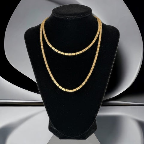 Vintage modernist gold tone cylinder bead necklace shown in various angles, including close‑ups of the textured beads and full‑length views.