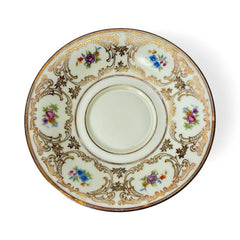 Vintage Tirschenreuth Bavaria demi-tasse and saucer set in cream porcelain with ornate floral clusters and gold scrollwork; footed teacup with gilded handle and rim, saucer marked with crown and shield logo and red glaze number 2284.