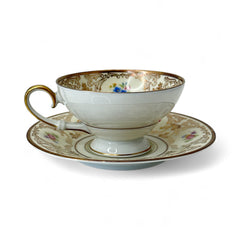 Vintage Tirschenreuth Bavaria demi-tasse and saucer set in cream porcelain with ornate floral clusters and gold scrollwork; footed teacup with gilded handle and rim, saucer marked with crown and shield logo and red glaze number 2284.