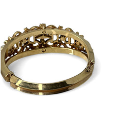 Vintage Trifari “Clair de Lune” bracelet by Alfred Philippe, gold-plated hinged bangle with crescent-shaped opalized faux moonstones, sapphire blue and clear rhinestones, shown in various lighting and angles to highlight design and craftsmanship