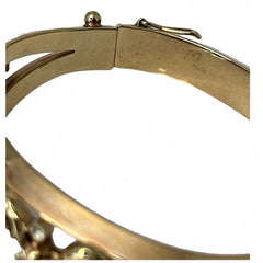 Vintage Trifari “Clair de Lune” bracelet by Alfred Philippe, gold-plated hinged bangle with crescent-shaped opalized faux moonstones, sapphire blue and clear rhinestones, shown in various lighting and angles to highlight design and craftsmanship