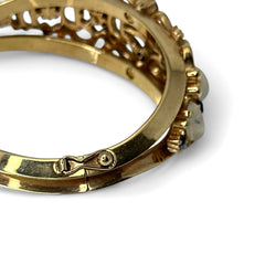 Vintage Trifari “Clair de Lune” bracelet by Alfred Philippe, gold-plated hinged bangle with crescent-shaped opalized faux moonstones, sapphire blue and clear rhinestones, shown in various lighting and angles to highlight design and craftsmanship