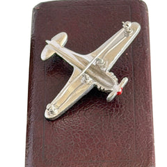 Vintage Trifari airplane brooch with clear stones, red nose detail, and blue enamel accents.