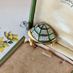 Vintage gold tone turtle brooch with green enamel shell and clear rhinestones, viewed from front and back.