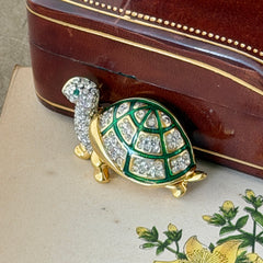 Vintage gold tone turtle brooch with green enamel shell and clear rhinestones, viewed from front and back.