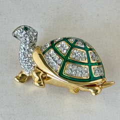 Vintage gold tone turtle brooch with green enamel shell and clear rhinestones, viewed from front and back.