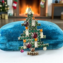 Vintage 1950s Christmas tree brooch with green, red, amber, and clear rhinestones in a gold tone setting, featuring five candle-like stones and a teardrop topper; unsigned Weiss style, very good condition.