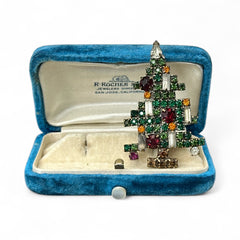 Vintage 1950s Christmas tree brooch with green, red, amber, and clear rhinestones in a gold tone setting, featuring five candle-like stones and a teardrop topper; unsigned Weiss style, very good condition.