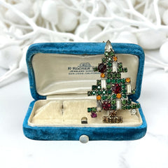 Vintage 1950s Christmas tree brooch with green, red, amber, and clear rhinestones in a gold tone setting, featuring five candle-like stones and a teardrop topper; unsigned Weiss style, very good condition.