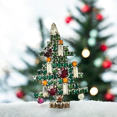 Vintage 1950s Christmas tree brooch with green, red, amber, and clear rhinestones in a gold tone setting, featuring five candle-like stones and a teardrop topper; unsigned Weiss style, very good condition.