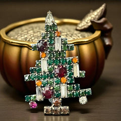 Vintage 1950s Christmas tree brooch with green, red, amber, and clear rhinestones in a gold tone setting, featuring five candle-like stones and a teardrop topper; unsigned Weiss style, very good condition.