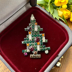 Vintage 1950s Christmas tree brooch with green, red, amber, and clear rhinestones in a gold tone setting, featuring five candle-like stones and a teardrop topper; unsigned Weiss style, very good condition.