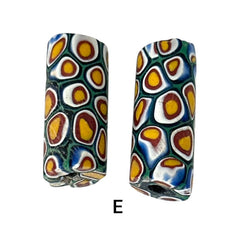 A set of vintage Venetian millefiori African trade beads in vibrant green and yellow. The tube-shaped glass beads, originating from Ghana, feature intricate floral patterns and showcase the rich history of 19th and 20th-century trade. Some beads show minor chips due to age, adding to their authentic vintage charm.