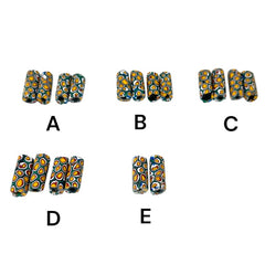 A set of vintage Venetian millefiori African trade beads in vibrant green and yellow. The tube-shaped glass beads, originating from Ghana, feature intricate floral patterns and showcase the rich history of 19th and 20th-century trade. Some beads show minor chips due to age, adding to their authentic vintage charm.
