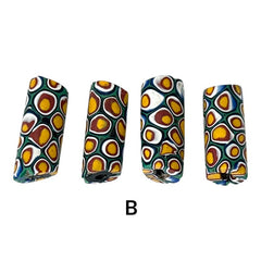 A set of vintage Venetian millefiori African trade beads in vibrant green and yellow. The tube-shaped glass beads, originating from Ghana, feature intricate floral patterns and showcase the rich history of 19th and 20th-century trade. Some beads show minor chips due to age, adding to their authentic vintage charm.