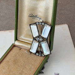 Vintage Victorian silver‑tone bow brooch with emerald‑cut clear glass stones and paste rhinestones, shown from multiple angles highlighting its antique patina and craftsmanship.