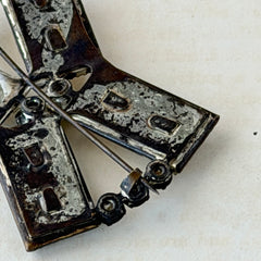 Vintage Victorian silver‑tone bow brooch with emerald‑cut clear glass stones and paste rhinestones, shown from multiple angles highlighting its antique patina and craftsmanship.