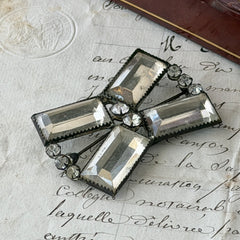 Vintage Victorian silver‑tone bow brooch with emerald‑cut clear glass stones and paste rhinestones, shown from multiple angles highlighting its antique patina and craftsmanship.