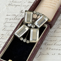 Vintage Victorian silver‑tone bow brooch with emerald‑cut clear glass stones and paste rhinestones, shown from multiple angles highlighting its antique patina and craftsmanship.