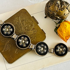 Vintage Victorian Revival gold‑tone bracelet with round black disks, filigree floral overlays, and clear rhinestone centers shown in various angles and styling arrangements.