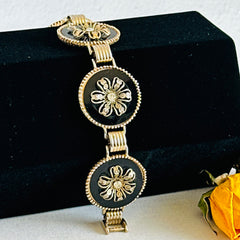 Vintage Victorian Revival gold‑tone bracelet with round black disks, filigree floral overlays, and clear rhinestone centers shown in various angles and styling arrangements.