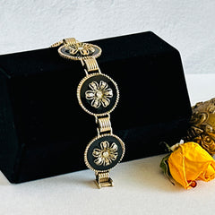 Vintage Victorian Revival gold‑tone bracelet with round black disks, filigree floral overlays, and clear rhinestone centers shown in various angles and styling arrangements.