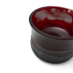 Vintage Villeroy & Boch ruby red glass vase with modernist etched pattern, shown on a neutral surface. The low, wide silhouette and translucent red hue evoke sculptural elegance, with geometric etching wrapping around the bowl. Signed on the underside, this French glass piece reflects 1980s–1990s design clarity