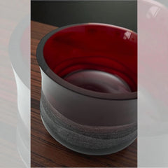 Vintage Villeroy & Boch ruby red glass vase with modernist etched pattern, shown on a neutral surface. The low, wide silhouette and translucent red hue evoke sculptural elegance, with geometric etching wrapping around the bowl. Signed on the underside, this French glass piece reflects 1980s–1990s design clarity