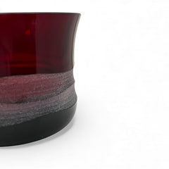 Vintage Villeroy & Boch ruby red glass vase with modernist etched pattern, shown on a neutral surface. The low, wide silhouette and translucent red hue evoke sculptural elegance, with geometric etching wrapping around the bowl. Signed on the underside, this French glass piece reflects 1980s–1990s design clarity