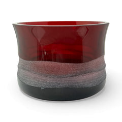 Vintage Villeroy & Boch ruby red glass vase with modernist etched pattern, shown on a neutral surface. The low, wide silhouette and translucent red hue evoke sculptural elegance, with geometric etching wrapping around the bowl. Signed on the underside, this French glass piece reflects 1980s–1990s design clarity