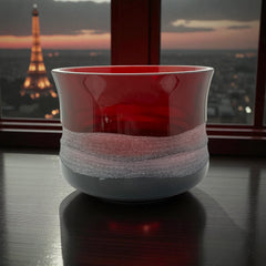 Vintage Villeroy & Boch ruby red glass vase with modernist etched pattern, shown on a neutral surface. The low, wide silhouette and translucent red hue evoke sculptural elegance, with geometric etching wrapping around the bowl. Signed on the underside, this French glass piece reflects 1980s–1990s design clarity