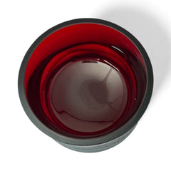 Vintage Villeroy & Boch ruby red glass vase with modernist etched pattern, shown on a neutral surface. The low, wide silhouette and translucent red hue evoke sculptural elegance, with geometric etching wrapping around the bowl. Signed on the underside, this French glass piece reflects 1980s–1990s design clarity