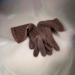 Vintage medium-length brown cotton gloves with a raised knit pattern on the arm and back of the hand, gently worn and in very good condition, laid flat to show texture and detail.