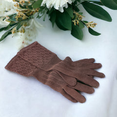 Vintage medium-length brown cotton gloves with a raised knit pattern on the arm and back of the hand, gently worn and in very good condition, laid flat to show texture and detail.