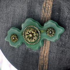 Vintage Vogue Bijoux green resin statement brooch with gold‑tone floral motifs and clear rhinestones.