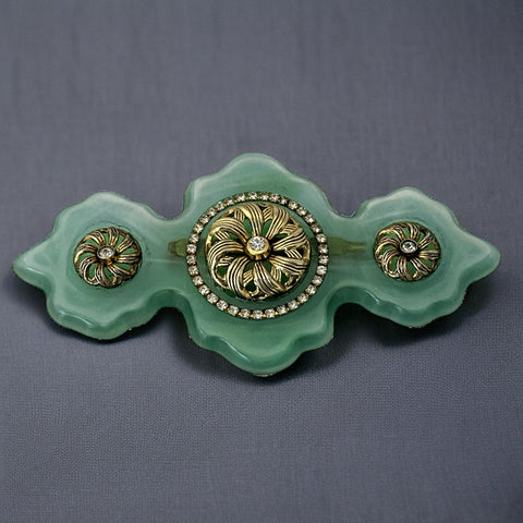 Vintage Vogue Bijoux green resin statement brooch with gold‑tone floral motifs and clear rhinestones.