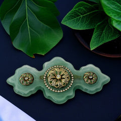 Vintage Vogue Bijoux green resin statement brooch with gold‑tone floral motifs and clear rhinestones.