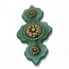 Vintage Vogue Bijoux green resin statement brooch with gold‑tone floral motifs and clear rhinestones.