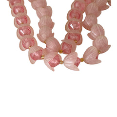 Vintage 1950s West Germany double-strand necklace displayed on black velvet stand, featuring frosted pink plastic petal beads encasing darker pink faceted centers, finished with a round pink cabochon clasp.