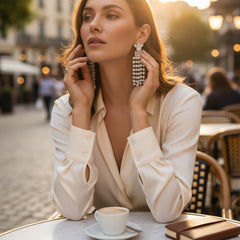 Vintage 1960s clip-on earrings with cascading clear rhinestone dangles, featuring chaton and baguette stones in a waterfall design