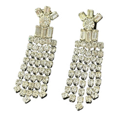 Vintage 1960s clip-on earrings with cascading clear rhinestone dangles, featuring chaton and baguette stones in a waterfall design