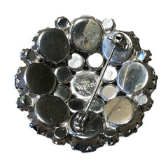  A stunning vintage Weiss crystal dome brooch in shades of blue and teal, paired with a double strand of shiny blue and gray faceted labradorite rondelles. The brooch can be worn centered, off-center, or separately, offering versatile styling. Finished with sterling silver spacers and a toggle clasp, this unique piece blends vintage charm with modern craftsmanship, signed Weiss on the back and featuring the EM tag in Etruscan alphabet for Elisabeth Michel-Meyrueix.
