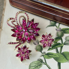 Vintage Weiss fuchsia rhinestone floral brooch and matching clip‑on earrings in light gold tone with layered petal design.