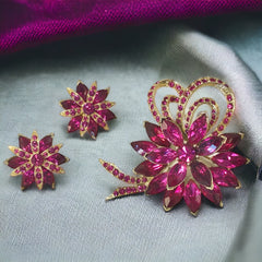 Vintage Weiss fuchsia rhinestone floral brooch and matching clip‑on earrings in light gold tone with layered petal design.