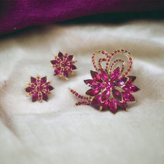 Vintage Weiss fuchsia rhinestone floral brooch and matching clip‑on earrings in light gold tone with layered petal design.