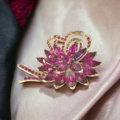 Vintage Weiss fuchsia rhinestone floral brooch and matching clip‑on earrings in light gold tone with layered petal design.