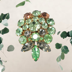 Vintage Weiss green and smoked topaz rhinestone teardrop brooch with gold‑tone setting.